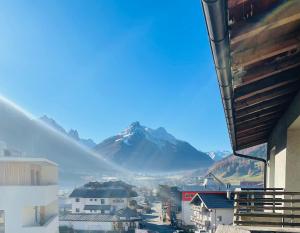 a view of a mountain from a building with a city at bergfried - Designwohnung mit Weitblick in Fulpmes