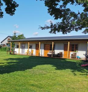 a house with a lawn in front of it at Agroturystyka Sielanka in Przasnysz