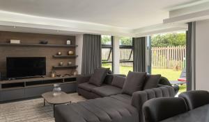 a living room with a couch and a television at 1 Licorna Beach in Durban