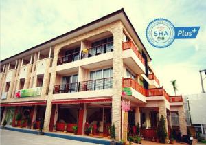 un edificio con un cartel de hotel en The Orchid House - SHA Extra Plus, en Kata Beach