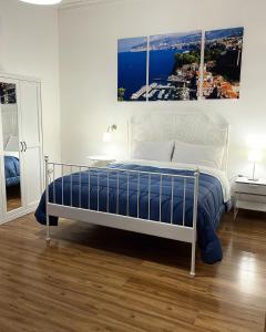 a bedroom with a bed with a painting on the wall at B&B Acqua Azzurra in Castellammare di Stabia