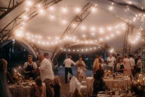 a group of people in a tent with lights at Sosnovel in Voropayev