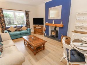 a living room with a couch and a table at Elm Cottage in Bishop Auckland