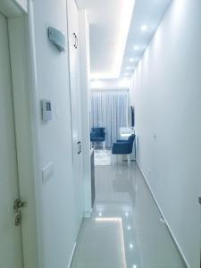 a corridor of a hospital with a door and a chair at City Center & Seaside LUX Apartment in Bar