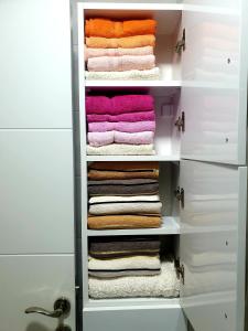 a walk in closet filled with towels at LUX Apartment - Central Place Bar in Bar