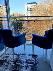 two chairs sitting in front of a window at City Center & Seaside LUX Apartment in Bar