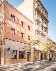 a large brick building on a city street at Hostal Baler in Barcelona