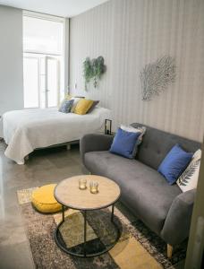 a living room with a couch and a bed at Casa Chinitas Holiday Homes in Málaga