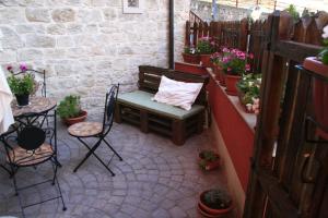 a patio with a bench and a table and chairs at La Casa di Petra in Modica