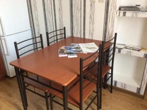a wooden table and chairs in a kitchen at Studio Lermontov Street in Tbilisi City