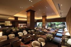 a restaurant with chairs and tables and a bar at Hotel Metropolitan Sendai in Sendai