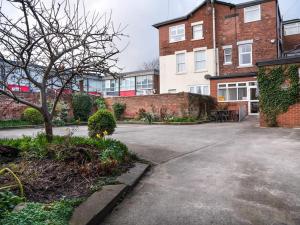 an empty driveway in front of a brick building at Fox lodge in Blackpool