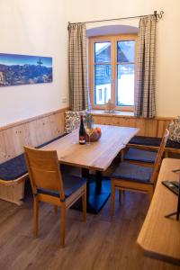 a dining room with a wooden table and chairs at Pfarrhofbauer in Sankt Martin bei Lofer