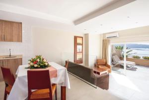a kitchen and dining room with a table with flowers on it at Apartamentos Vista Sur in Playa de las Americas
