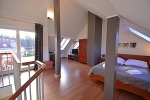 a bedroom with a bed and a balcony at Apartamenty Bryza - Family Home - Parking - Komandorska 3E-3G in Świnoujście