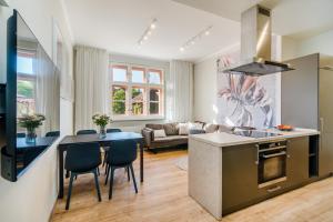 a kitchen and living room with a table and chairs at Bright Apartment in Michle by Prague Days in Prague