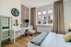a bedroom with a bed and a desk and a window at Bright Apartment in Michle by Prague Days in Prague