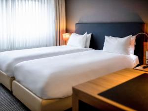Tempat tidur dalam kamar di Mercure Hotel Den Haag Central