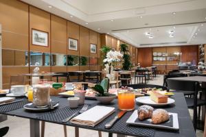 a table with food on it in a restaurant at Hotel Cappello D'Oro, BW Signature Collection in Bergamo
