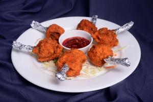 a plate of food with chicken tenders and dipping sauce at The Hawaii Comforts Panjim in Panaji