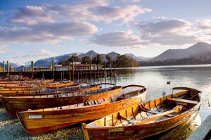 a group of boats sitting on the shore of a lake at Abacourt House in Keswick