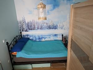 a bed in a room with a painting on the wall at Apartman Mina in Kopaonik