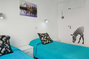 a room with a bed and a zebra picture on the wall at Apartamento Mirra - Beach view in Puerto Rico de Gran Canaria