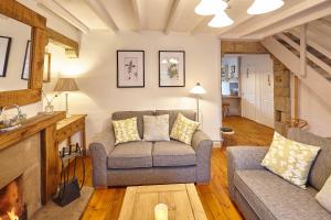 a living room with a couch and a fireplace at Host & Stay - Green Willow in Masham