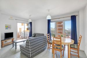 a living room with a table and a couch at Edificio Los Martines in El Médano