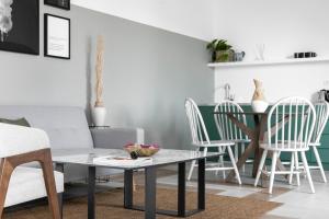 a living room with a table and chairs at Play Theatrou Athens a member of Brown Hotels in Athens +87 photos