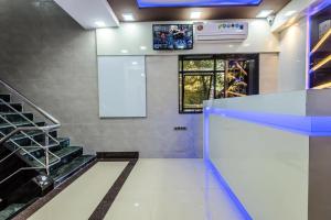 a lobby with blue lights and a tv on the wall at Hotel Plaza- Near Byculla Railway Station in Mumbai