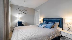 een slaapkamer met een groot bed met blauwe kussens bij HvileStay Sopot - prywatne miejsce parkingowe in Sopot