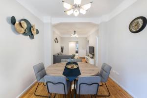a dining room with a table and blue chairs at Porto Sea View Apartments - Kypriou in Thessaloniki