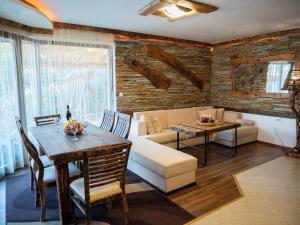 a living room with a couch and a table at Pamporovo Villa in Pamporovo
