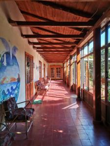 een lege hal van een gebouw met stoelen en ramen bij Casona Patrimonial Cobquecura Hotel Boutique in Cobquecura