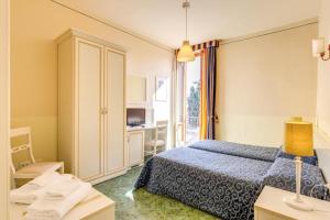 a hotel room with a bed and a window at Hotel Marine in Florence