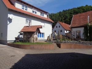 una casa con una estructura de piedra en un patio en Ferienhaus Zur kleinen Kneipe, en Fladungen