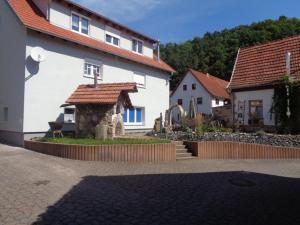 a house with a stone structure in a yard at Ferienhaus Zur kleinen Kneipe in Fladungen