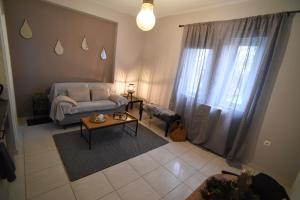 a living room with a couch and a table at Memory House in Megara