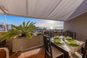 a dining table with a view of the ocean at MEDANO4YOU The Rosuca Holiday Home in El Médano