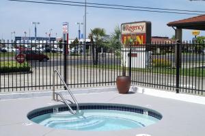 
a pool with a pool table and a fountain in front of it at Regency Inn in Vallejo
