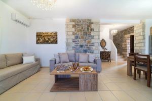 a living room with a couch and a table at Asfendamos Villas in Zonianá