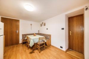a dining room with a table and chairs at Malgorerhof Sonja in San Genesio Atesino +22 photos