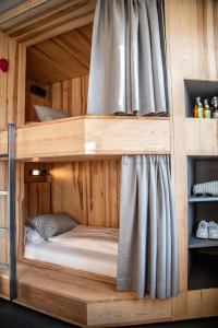 a bunk bed in a room with a curtain at St.Josefsheim in Schruns-Tschagguns