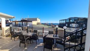 a patio with tables and chairs on a balcony at Grand Peninsula Hotel in Istanbul