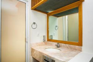 a bathroom with a sink and a mirror at Capital O Hotel Casa Blanca, Morelia in Morelia