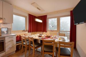 a kitchen with a table and chairs in a room at Alpenchalet Zillertal in Hippach