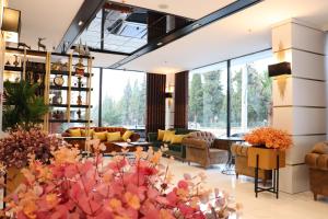 a living room with couches and tables and windows at Mes Hotel & Spa in Samsun