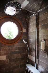 a bathroom with a window and a toilet in it at Lodges des grands crus in Chablis