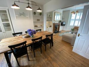 a kitchen and dining room with a wooden table and chairs at Pass The Keys Beautiful 3 Bedroom House with Great Views of Bath in Bath